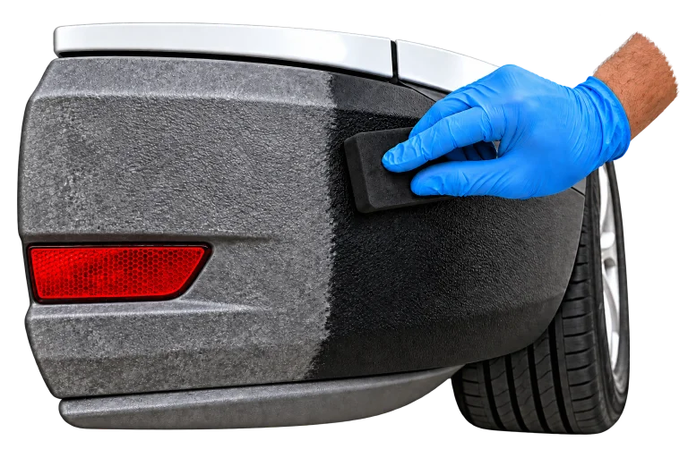 Faded gray bumper plastic beside restored black plastic, with a blue-gloved hand applying treatment